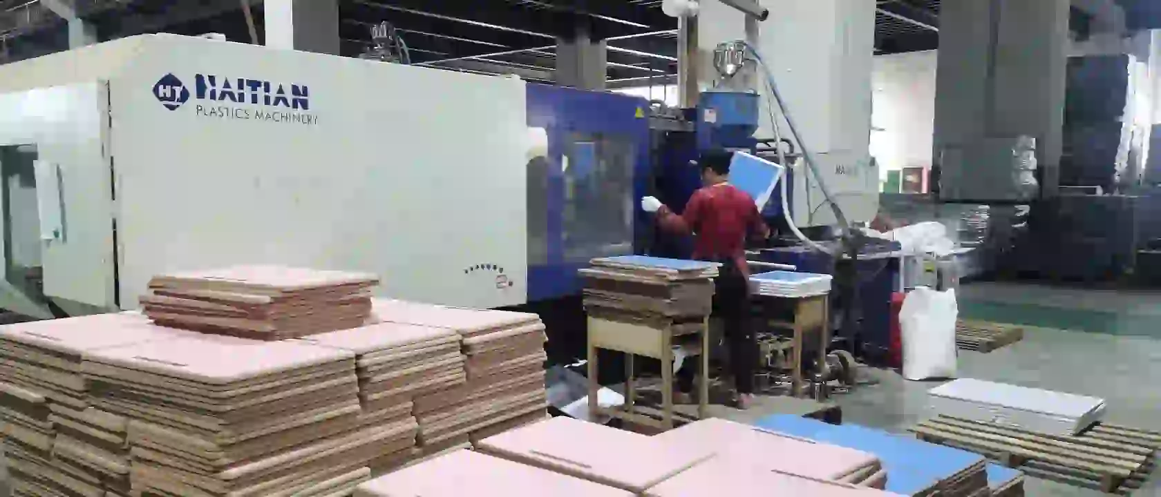 Stacks of desk tops waiting for the edge to be moulded